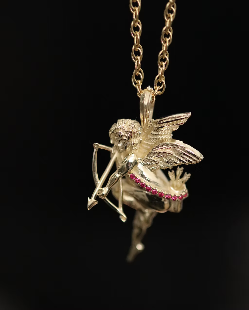 9k yellow gold Cherub pendants set with rubies